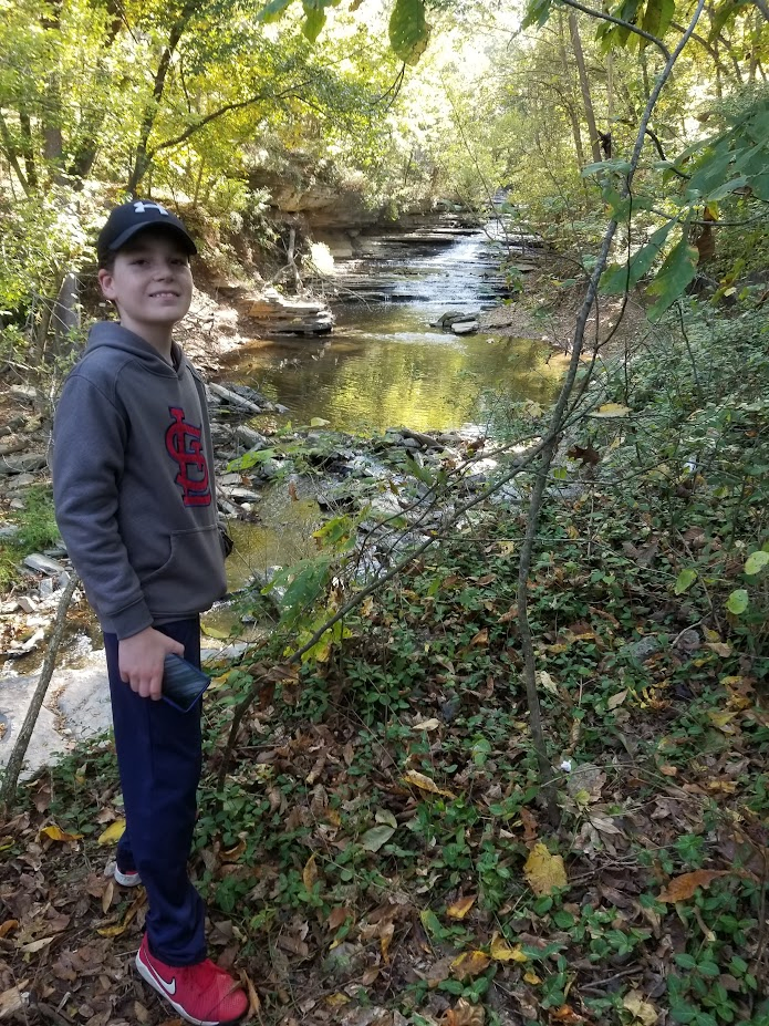 Boy next to stream at Nature Preserve