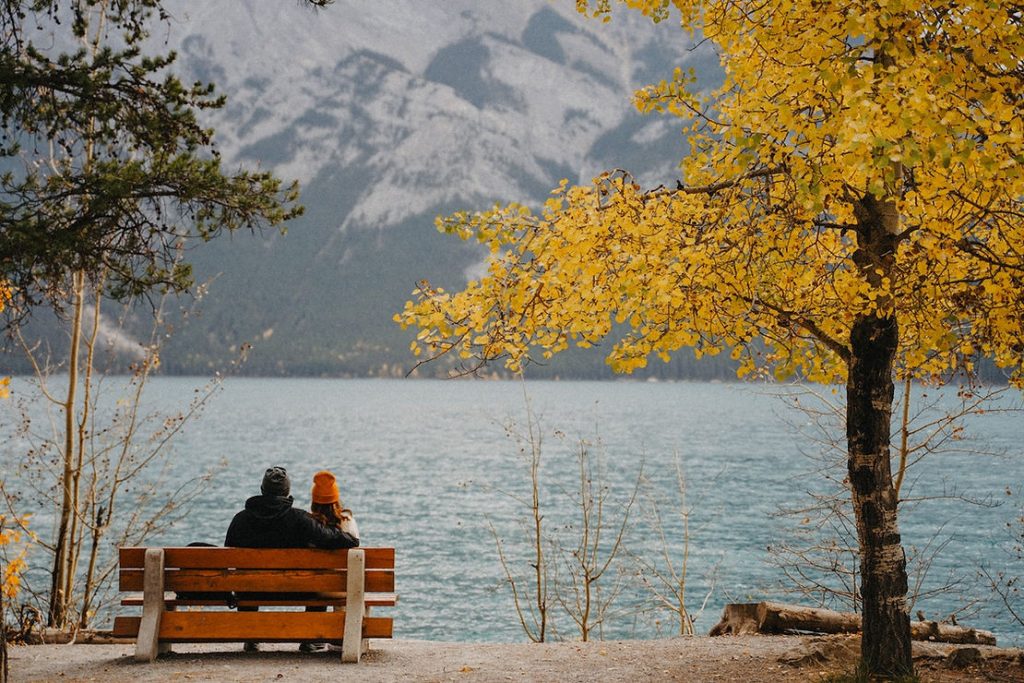 couple sitting by lake