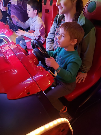 Child in arcade race car