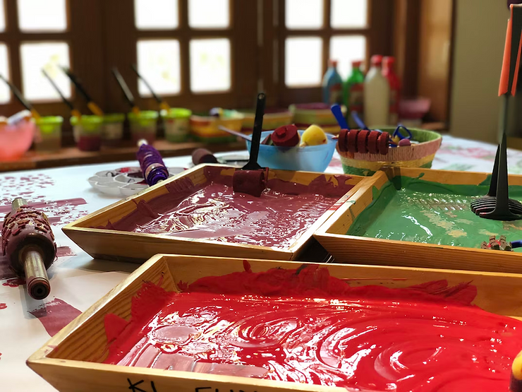 wet paints and stamps on table ready for artmaking