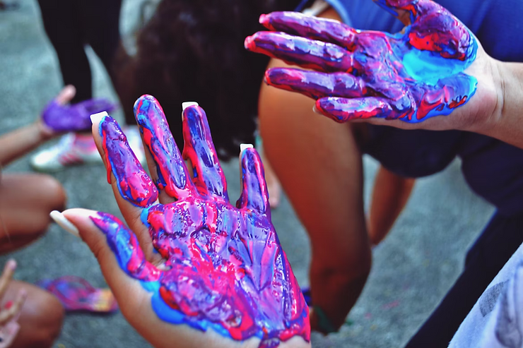 red and blue paint on womans palms