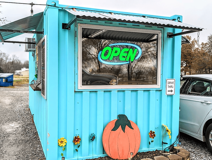 Turquoise storage container converted into a coffee shop called the coffee container in Hiwasse, Arkansas