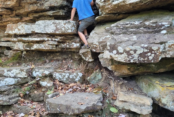 child climbing at devils den state park 