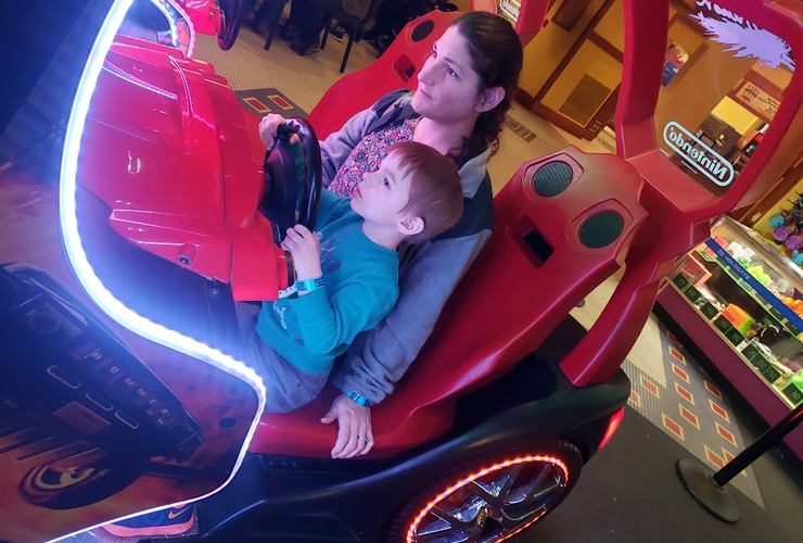 Child in arcade race car