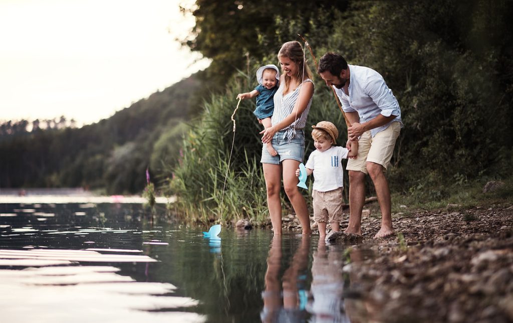 family dipping toes into the lake