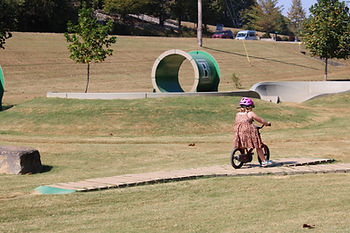 Young girl riding bike skills course