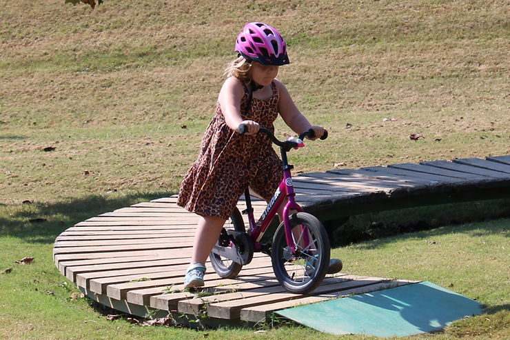 young girl riding bike skills course