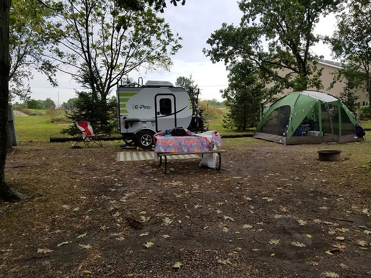 campsite with camper picnic table and tent