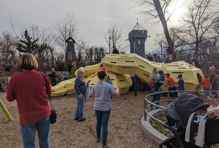 families gathered at play structure