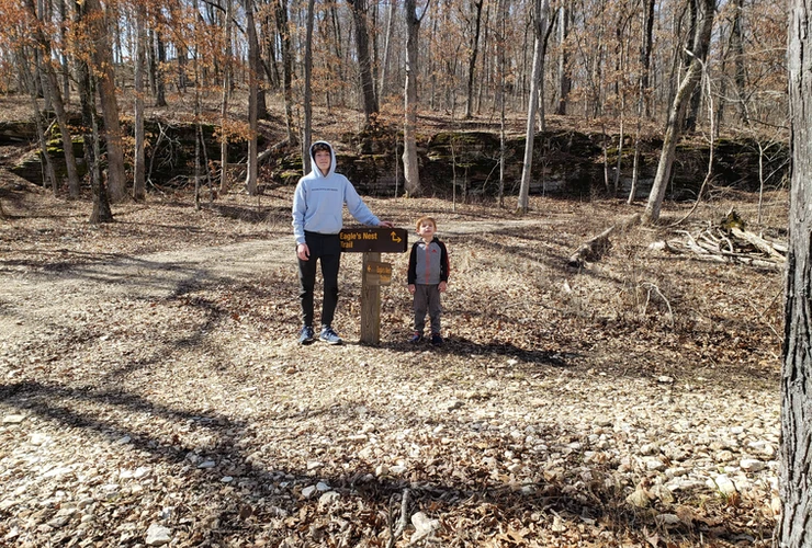 Kids standing next to park signage