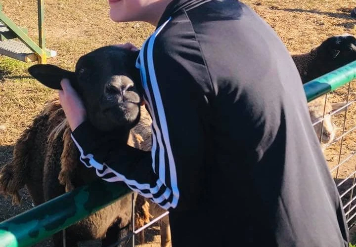 girl petting goat