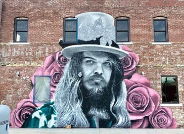 mural of man in black and white with pink rose background