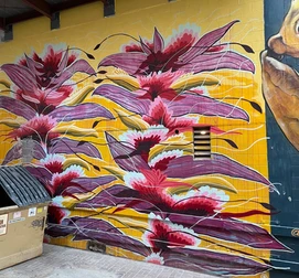 Mural of red flowers with purple leaves on yellow background