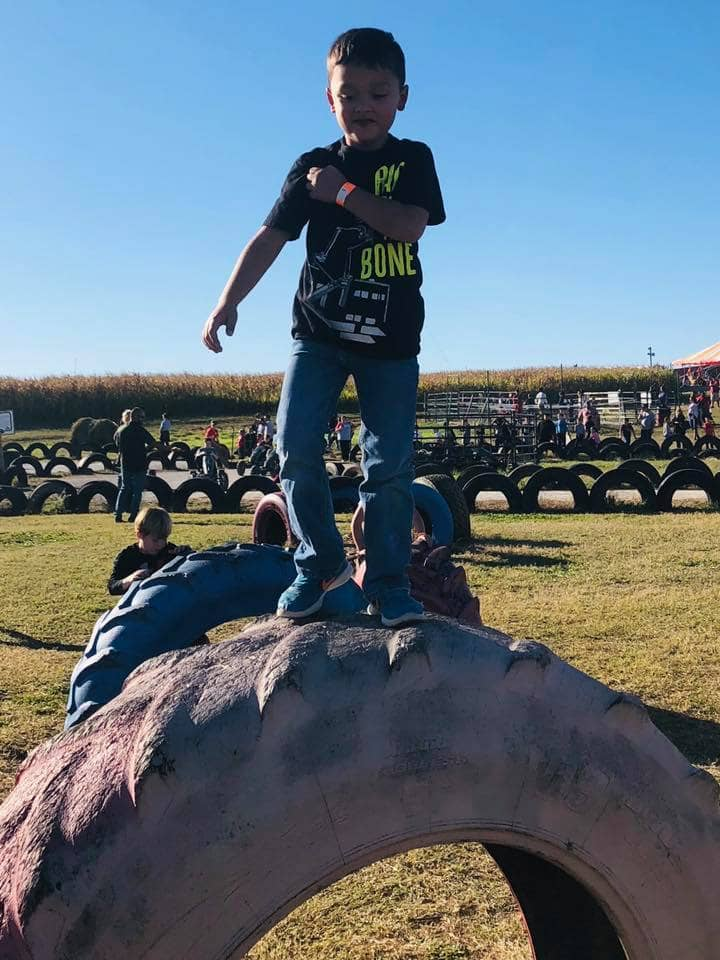 child on tractor tire